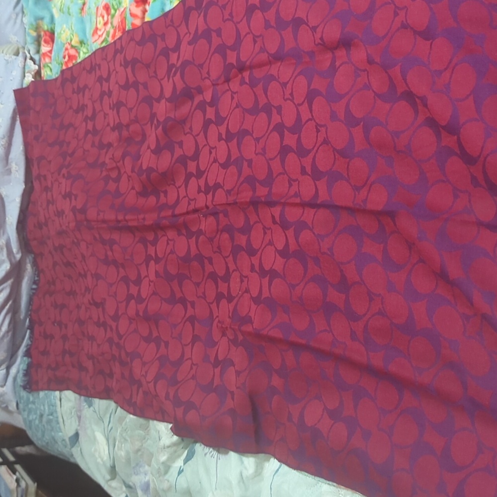 Long coach scarf with purple and pick undertones.